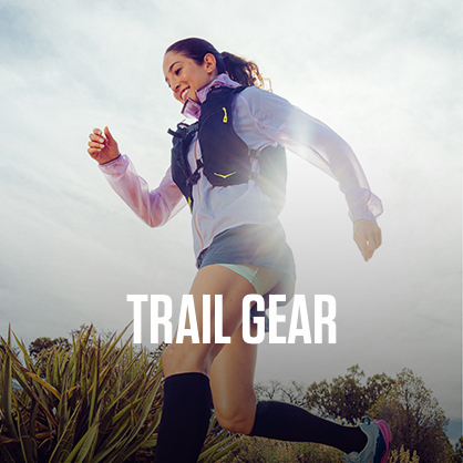 Shop trail running. A woman running on a nature path